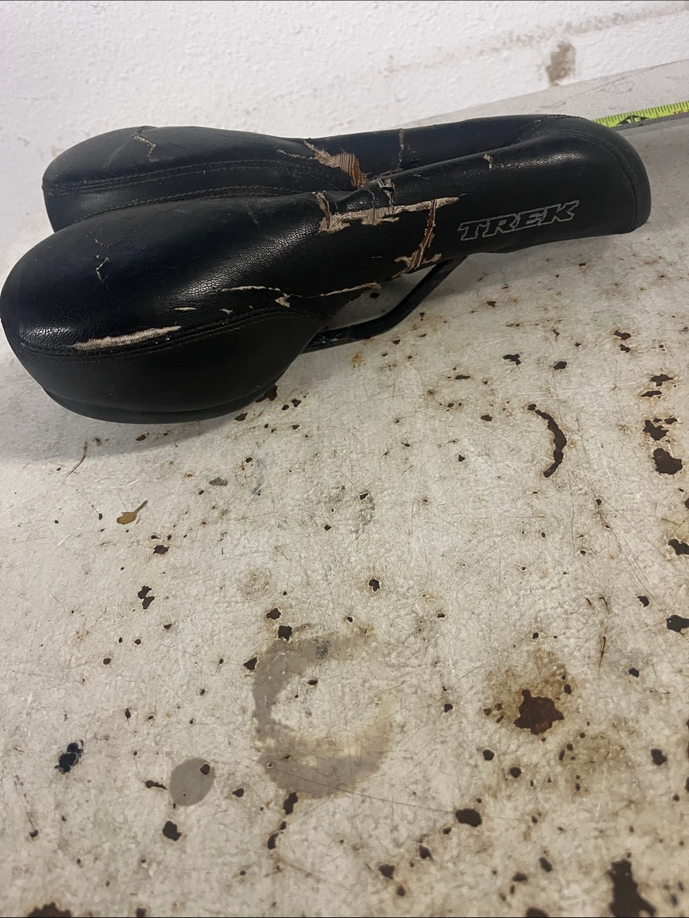 Item 92.  Trek Black Bike Saddle with Tear Detailing